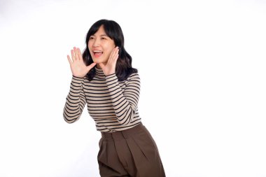 Happy asian woman, professional entrepreneur standing in casual clothing, open mouths raising hands shout announcement, white background