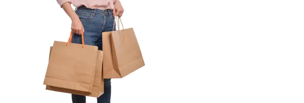 白い背景に隔離されたショッピングペーパーバッグを保持カジュアル服を持つ女性の手のクローズアップ 生態系のショッピングパッケージコンセプト — ストック写真