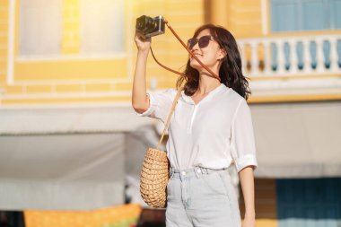 Asian woman traveler using camera. Asia summer tourism concept