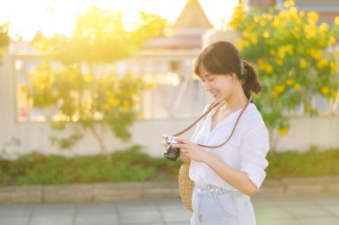 Asian woman traveler using camera. Asia summer tourism concept