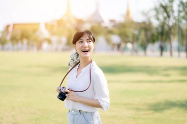 Asian woman traveler using camera. Asia summer tourism concept