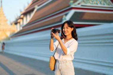 Asian woman traveler using camera. Asia summer tourism concept