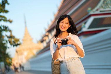Asian woman traveler using camera. Asia summer tourism concept