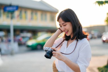 Asian woman traveler using camera. Asia summer tourism concept
