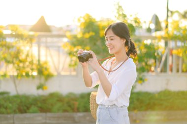Asian woman traveler using camera. Asia summer tourism concept