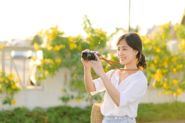 Asian woman traveler using camera. Asia summer tourism concept