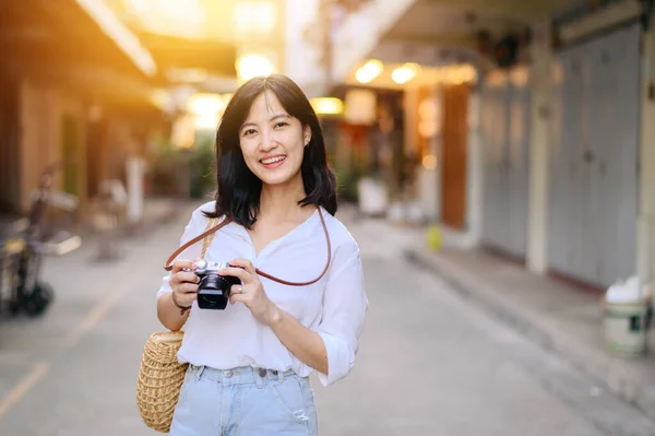 stock image Asian woman traveler using camera. Asia summer tourism concept