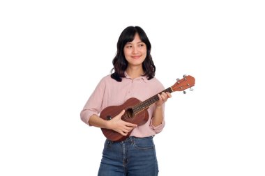 Ukulele çalan mutlu genç Asyalı kadın beyaz arka planda izole edilmiş.