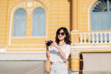 Asian woman traveler using camera. Asia summer tourism concept