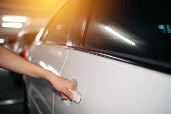 Business woman hand open person white car. Driver, service, lock, automotive insurance concept. Automobile vehicle female owner catching a door handle.