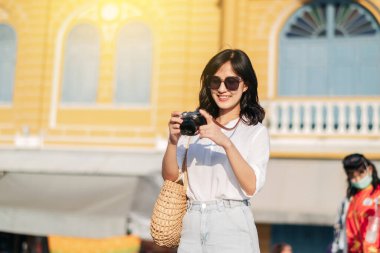 Asian woman traveler using camera. Asia summer tourism concept