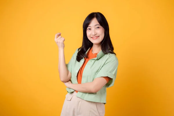 亚洲30多岁的快乐女人穿着绿色和橙色的衬衫 双手交叉 散发出自信和沉着 完美地抓住了自信的本质 展示了一个充满活力的时尚理念 — 图库照片