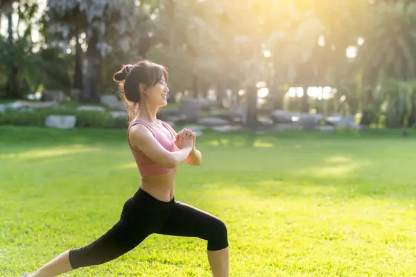 wellness and healthy lifestyle of female jogger. portrait captures Asian 30s woman in pink sportswear, preparing and stretching body and muscles before sunset running in public park. fitness outside.