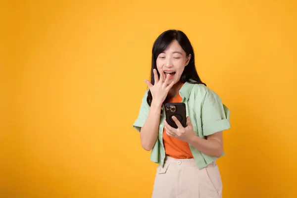 Surprise Captivating Young Asian Woman 30S Donning Orange Shirt Using — Stock Photo, Image