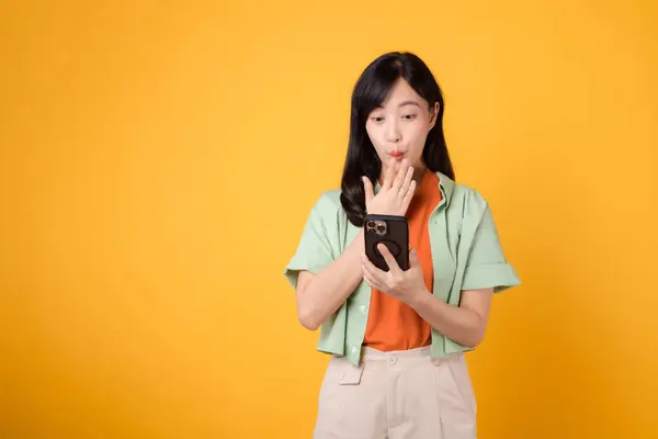 Surprised Young Asian Woman 30S Using Smartphone Orange Shirt Green — Stock Photo, Image