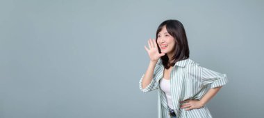 Yaratıcı gülümsemesi olan Güneydoğu Asyalı kadın, alışveriş yaparken ve mağazasını güvenle yönetirken perakende ve çevrimiçi mağaza sektöründeki küçük işletmesini destekliyor