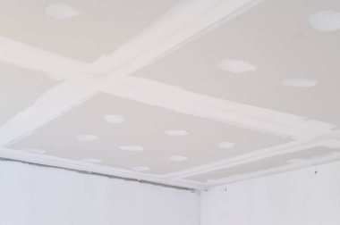 İç bina yenileme çalışmaları alçıtaşı tavan kurulumuyla devam ediyor. Pürüzsüz kenarlar, son bitişten önce uzman sıvası gerektirir. Elektrik kablosu hazırlama düz tavanlar için hayati önem taşıyor