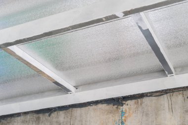 Yapısal metal kirişler, izolasyon köpüğüyle yapılan kompozit panel levhalarını destekliyor. Verimli termal bariyer inşaatlarda sıklıkla görülür.