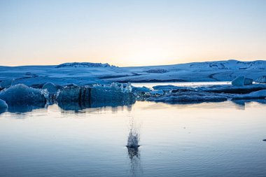 Gün batımında eriyen buzullar. Küresel ısınma Suda yüzen buz kütleleri. Dokunulmamış doğa. Manzara.