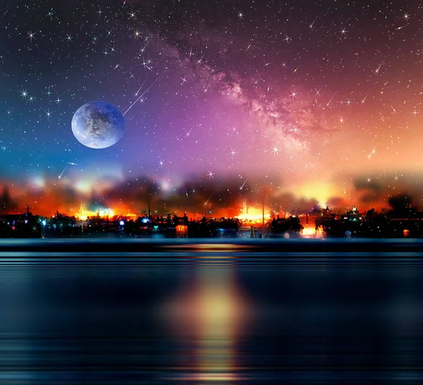 night sea  starry sky  in harbor ,blue sea water  nebula and big moon on sea on horizon city light blurred light