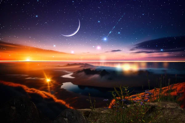 night at sea starry sky and moon on dramatic clouds sea water wave and stones on horizon blurred city light