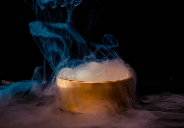 stock image Ice in a golden box with smoke, colorful smoke, blue smoke, gray smoke, ice in syrup, delicious ice. space picture on dark background