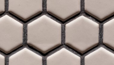 Dişsiz altıgen seramik seramik seramik seramik seramik kaplama, temiz, geometrik bir desen sergiliyor. Tarafsız tonlar ve harç hatları tasarım için ideal modern, minimalist bir yüzey yaratıyor.