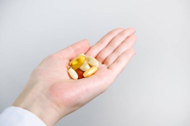 Kadının elindeki çeşitli takviyelerin yakın plan çekimi..