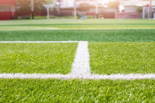 stock image Selective focus to white lines on green artificial grass football fields. Artificial turf soccer field, green background. Outdoor field.