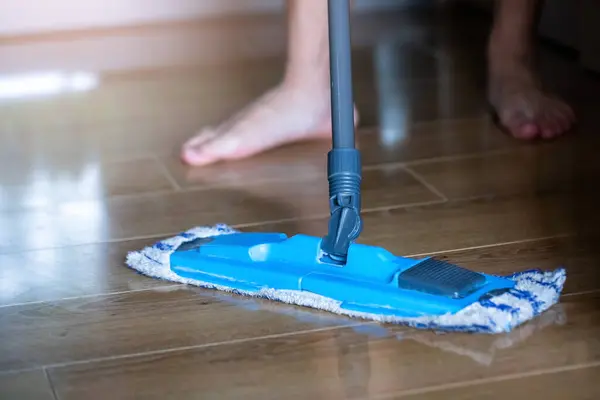 Selective focus to mop to clean floor surface. Cleaning floor with mop. The concept of cleaning service in home or office