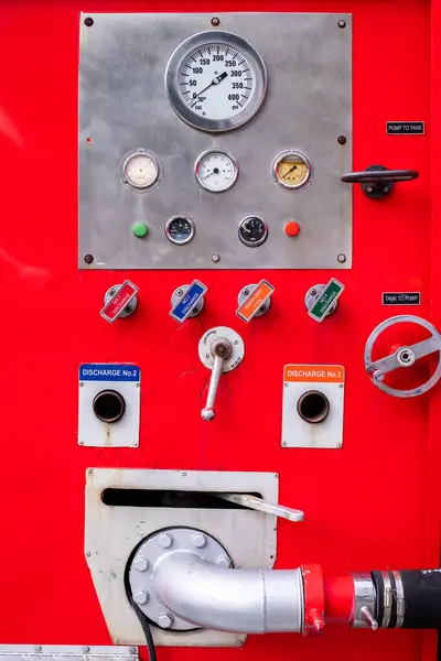 Meter and control switch are fire equipment on a red fire truck. Fire trucks are prepared in the event of a fire.