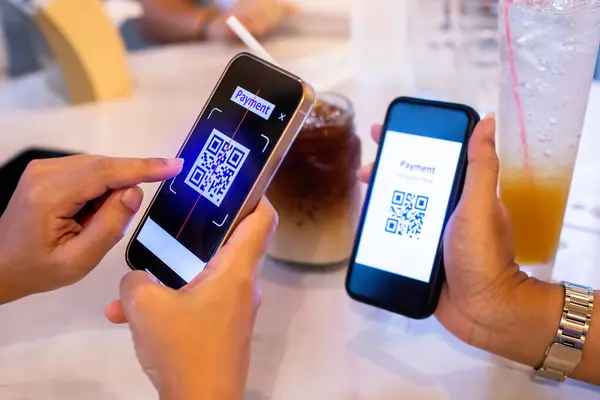 Hand using smart phone to scan QR code on tag with blurry soft drink  and customers in cafe or restaurant to accepted generate digital pay without money. Qr code payment concept.
