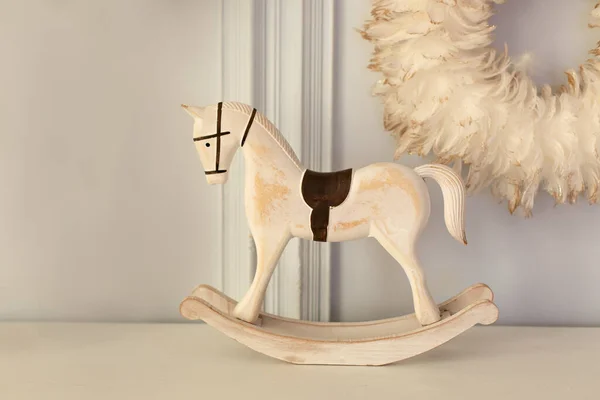 Christmas, Vintage figurine rocking horse. New Year, place for text. Carved wooden horse figurine. Decorative figurines of a Xmas theme. Decoration for a Christmas tree. Festive decor at home
