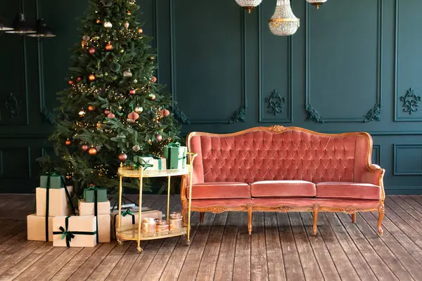 光輝くガーランドとクリスマスツリー 装飾されたクリスマスツリー ギフトとピンクのソファ付きの装飾的なトロリー付きのスタイリッシュなロフトリビングルームのインテリア 自宅でクリスマス 新年の冬の家の装飾 ストックフォト