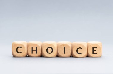 Choice word on wooden blocks on gray background. Copy space
