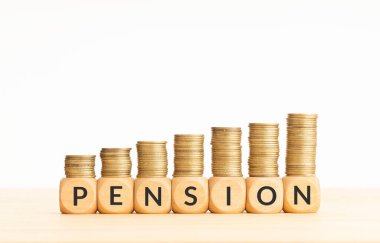 Pension word in wooden blocks with coins stacked in increasing stacks. Retire in wealth concept. Copy space clipart