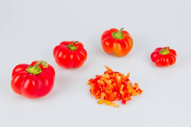 Beyaz arka planda izole edilmiş taze ve dilimlenmiş yeşil biber seti. Yukarıdan bak. Sebze doğrama. Tabak ve salata hazırlama