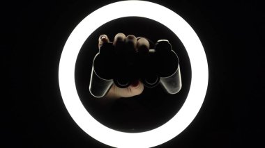 female hands hold a gamepad on a black background. joystick controller for gaming platform close-up. Esports and cybersports concept.