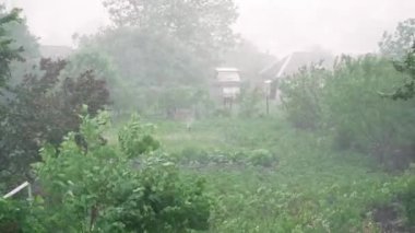 Heavy rain pouring down on roof of house. Storm rain at countryside. Thunderstorm rain drops fall on roof of house. Falling rain on roof of house
