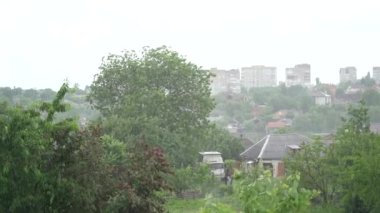 Heavy rain pouring down on roof of house. Storm rain at countryside. Thunderstorm rain drops fall on roof of house. Falling rain on roof of house