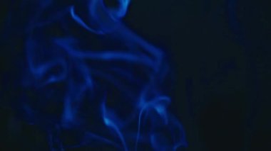 Incense sticks burn and smoke on a black background, incense smoke. Slow motion