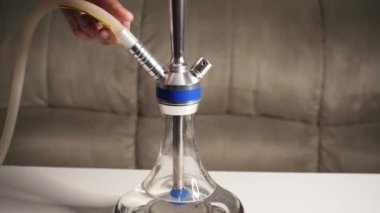 Cooking hookah. Step by step. A hookah man collects a hookah piece by piece in a hookah bar