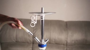 Cooking hookah. Step by step. A hookah man collects a hookah piece by piece in a hookah bar