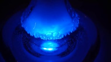 Liquid in a hookah communicate emotion shisha smoker lounge in the dark vape beautiful attractive company relax slow motion neon lights