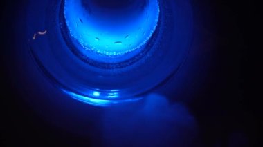 Liquid in a hookah communicate emotion shisha smoker lounge in the dark vape beautiful attractive company relax slow motion neon lights