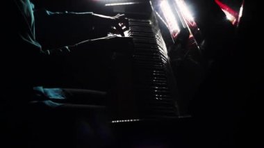 Pianist plays in beautiful grand piano on stage in concert. Close up. Footage of male hands playing grand piano. Man touches fingers on keys