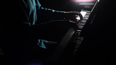 Pianist plays in beautiful grand piano on stage in concert. Close up. Footage of male hands playing grand piano. Man touches fingers on keys