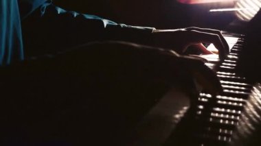 Pianist plays in beautiful grand piano on stage in concert. Close up. Footage of male hands playing grand piano. Man touches fingers on keys