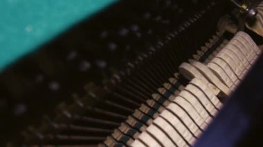 Inside of a piano. View inside the piano. Musical instrument strings. Details inside of the piano with hummers and strings