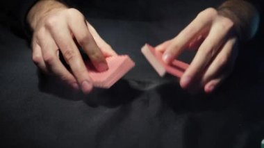 Poker table during the game. The player holds the cards in his hands. Chips and cards on the table. Gambling theme